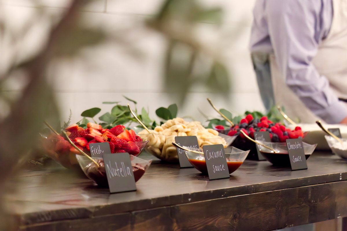 a series of containers holding crepe toppings